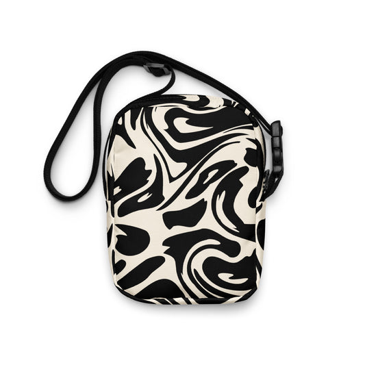 Adjustable utility crossbody bag with two pockets in fluid black and white print