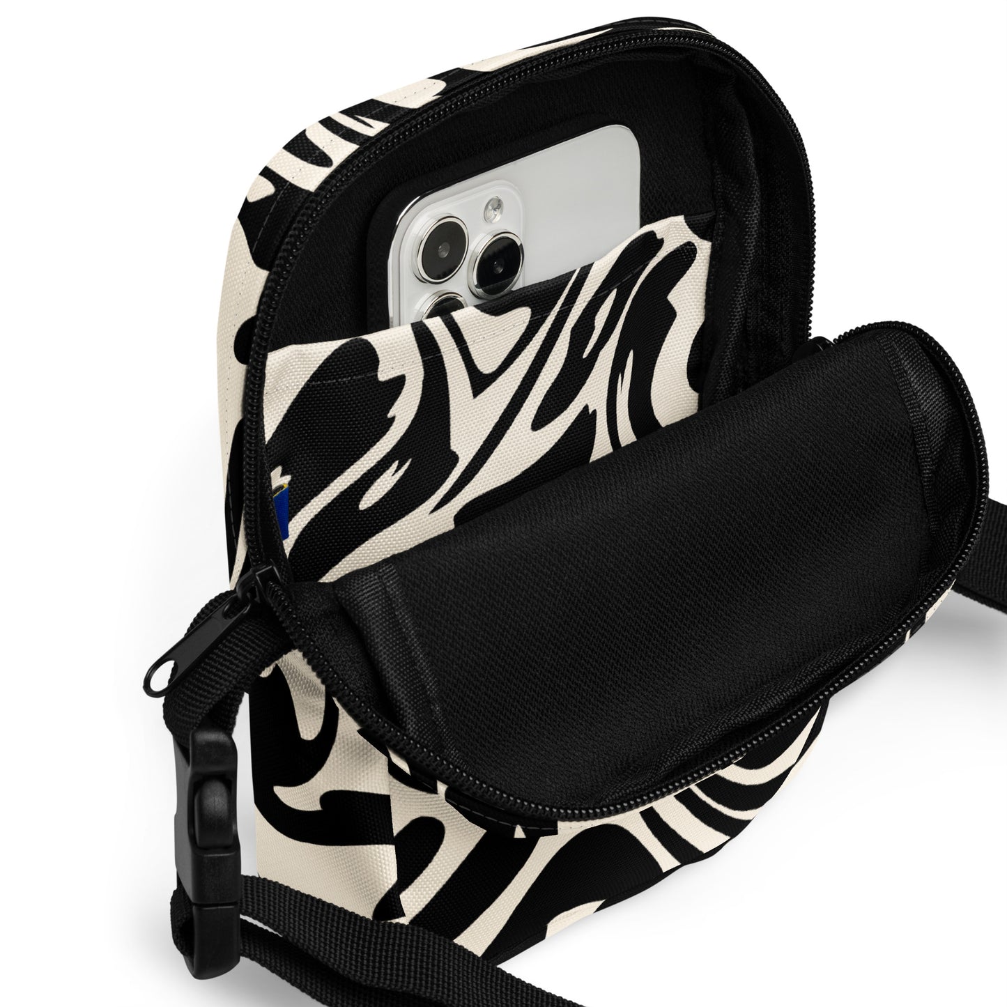 Adjustable utility crossbody bag with two pockets in fluid black and white print